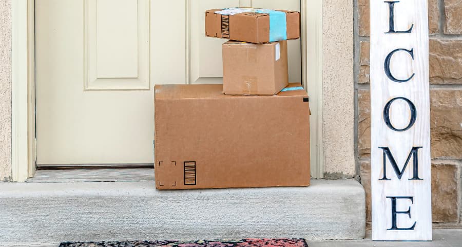 Boxes by the door of a residence with a welcome sign in Lynchburg